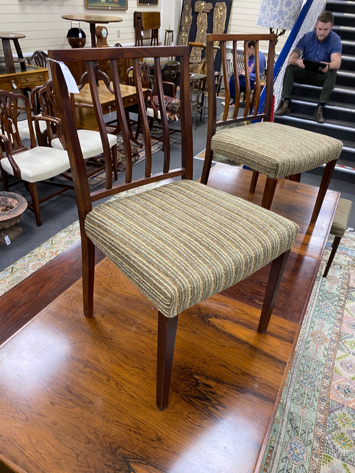 A mid century rosewood extending dining table, length 214cm extended, width 84cm, height 72cm six chairs and wall hanging side cabinet